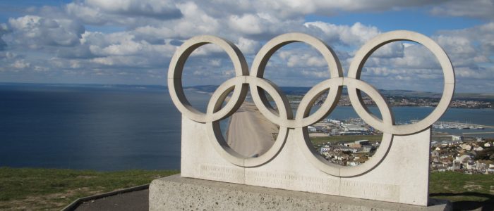 The Olympic Rings in Portland Limestone, overlooking Chesil Beach