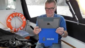 A shipmate all at sea with his new iPad!